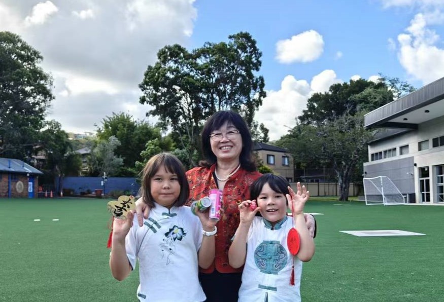 Huaxia's principal, Mary Zhang, with two students at Huaxia's Saturday Chinese School classes